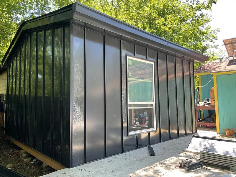 Black standing seam metal wall panels for Roof Inspection in Texas City