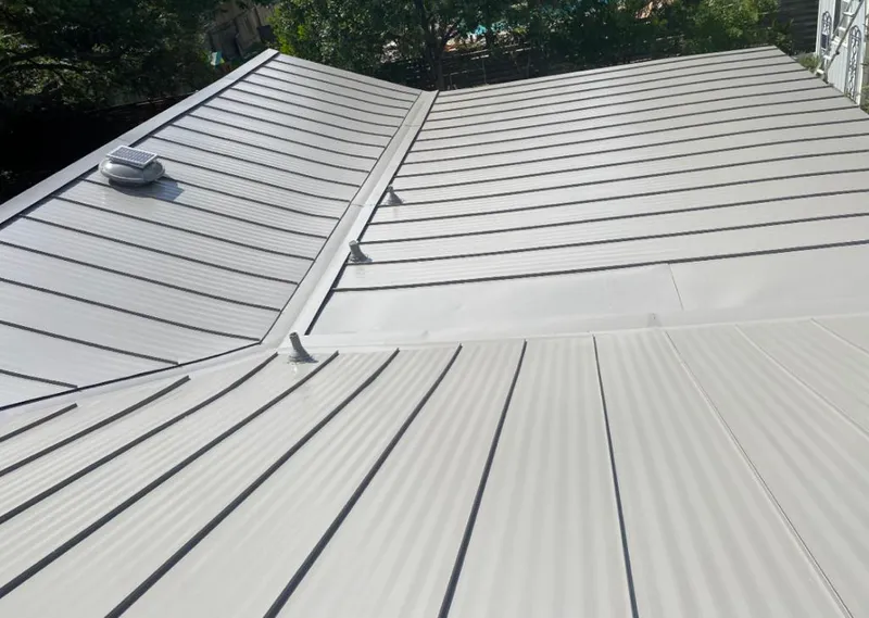 Solar attic fan installed on a metal roof for Roof Ventilation in Texas City