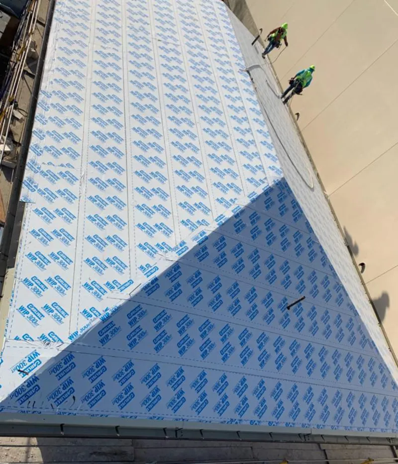 Professional roofers installing underlayment on a metal roof in Texas City